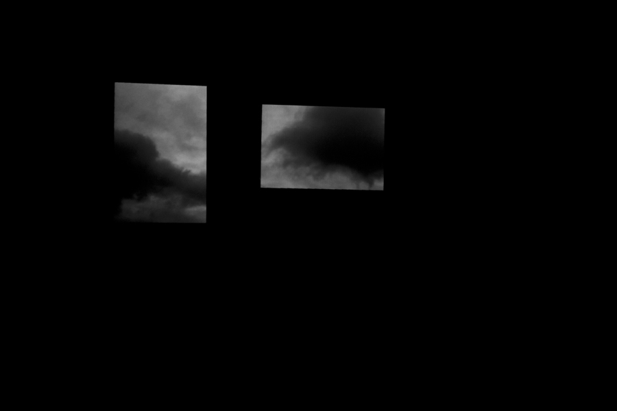 Talk to me like the rain video design, dark clouds hang over a dark stage